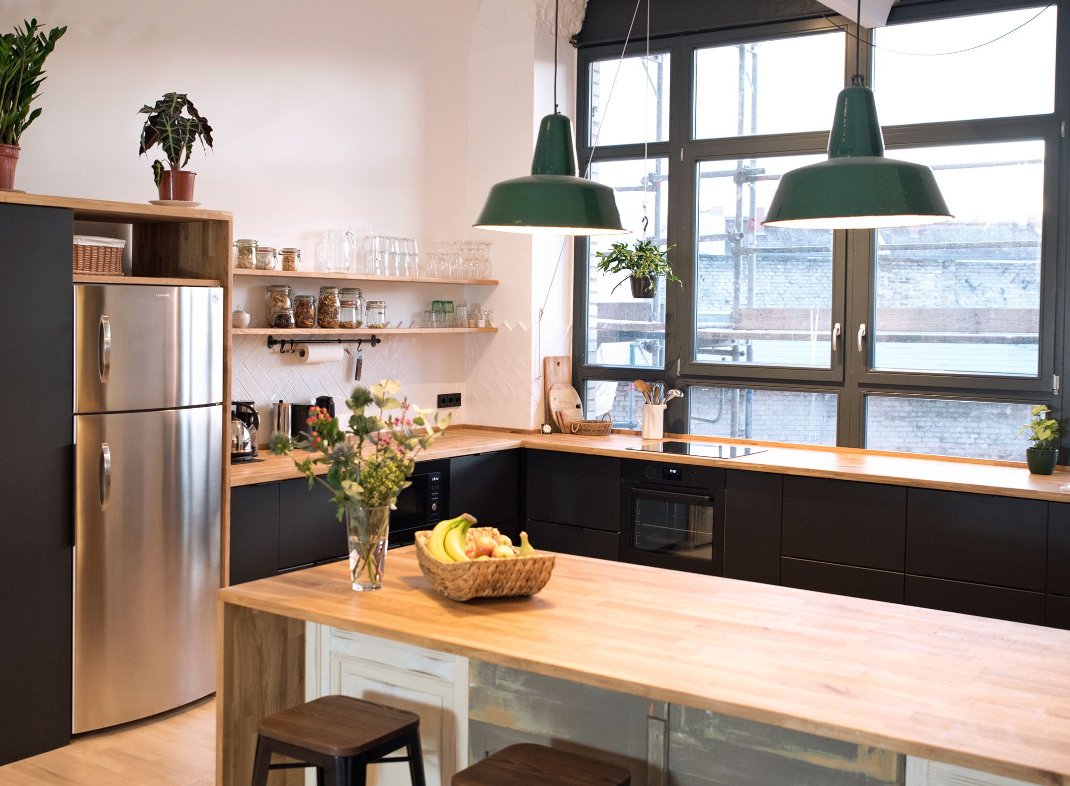 The cosy café style office kitchen with oak counters and industrial lamps
