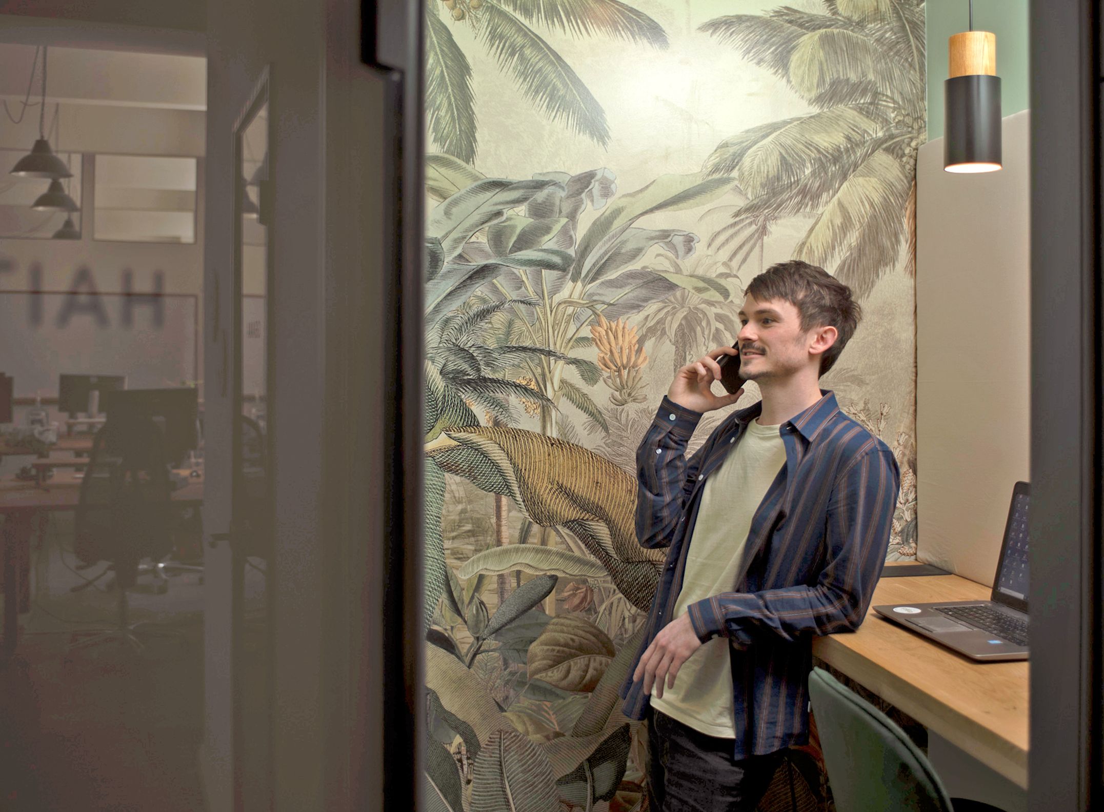 A colleague makes a call in a beautifully designed telephone booth